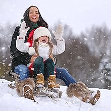 a mother and a child with strong immunity playing in the snow