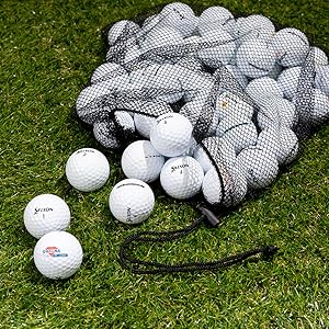 q-star golf balls on green turf grass