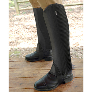 Image of a model's legs from the knee down wearing the half chaps standing on a wooden floor