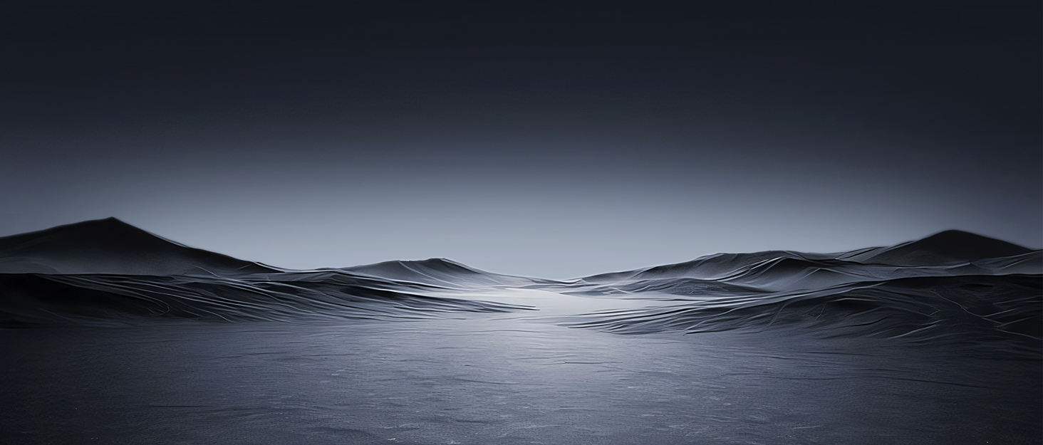 Minimalist landscape photograph showing dark rolling hills or mountains against a gradient gray sky, creating a moody atmospheric scene.