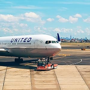 a united airlines plane on the tarmac at an airport.
