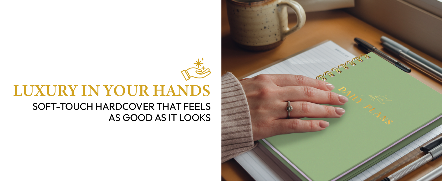 Hands holding a rust colored 'Daily Plans' planner with gold foil design at a café