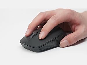 Hand demonstrating use of a black wireless computer mouse with textured grip pattern on its surface.