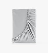 Close-up sequence of light gray fitted sheet corners, demonstrating elastic edge design and how it fits around mattress corners.