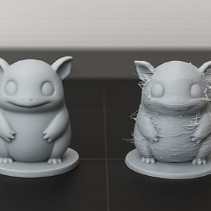 Successful 3D print next to failed print showing poor layer adhesion and stringing