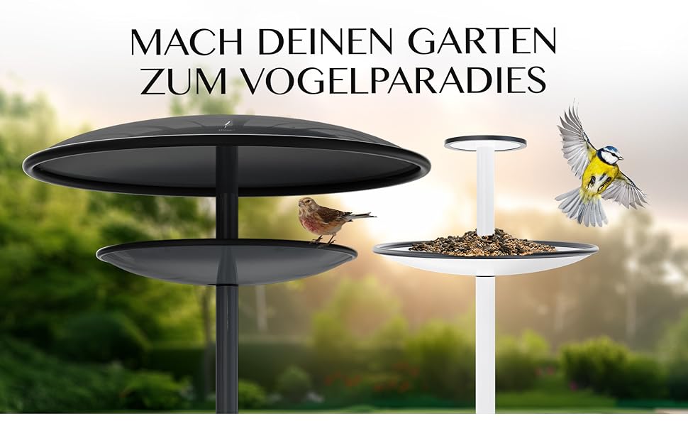 Modernes Vogelhäuschen mit zweistufigem, kreisförmigem Design in Schwarz. Abgebildet ist ein separater, weißer, einstöckiger Futterspender. Der Text auf Deutsch wirbt für die Schaffung eines Vogelparadieses in Ihrem Garten.