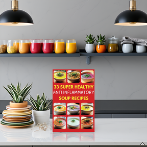 A rustic wooden table with a steaming bowl of soup surrounded by fresh vegetables and herbs.