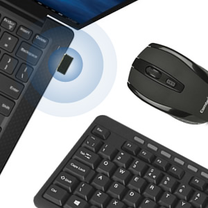 Wireless computer peripherals set including a black keyboard and mouse. Blue glow indicates wireless connectivity to a nearby laptop.