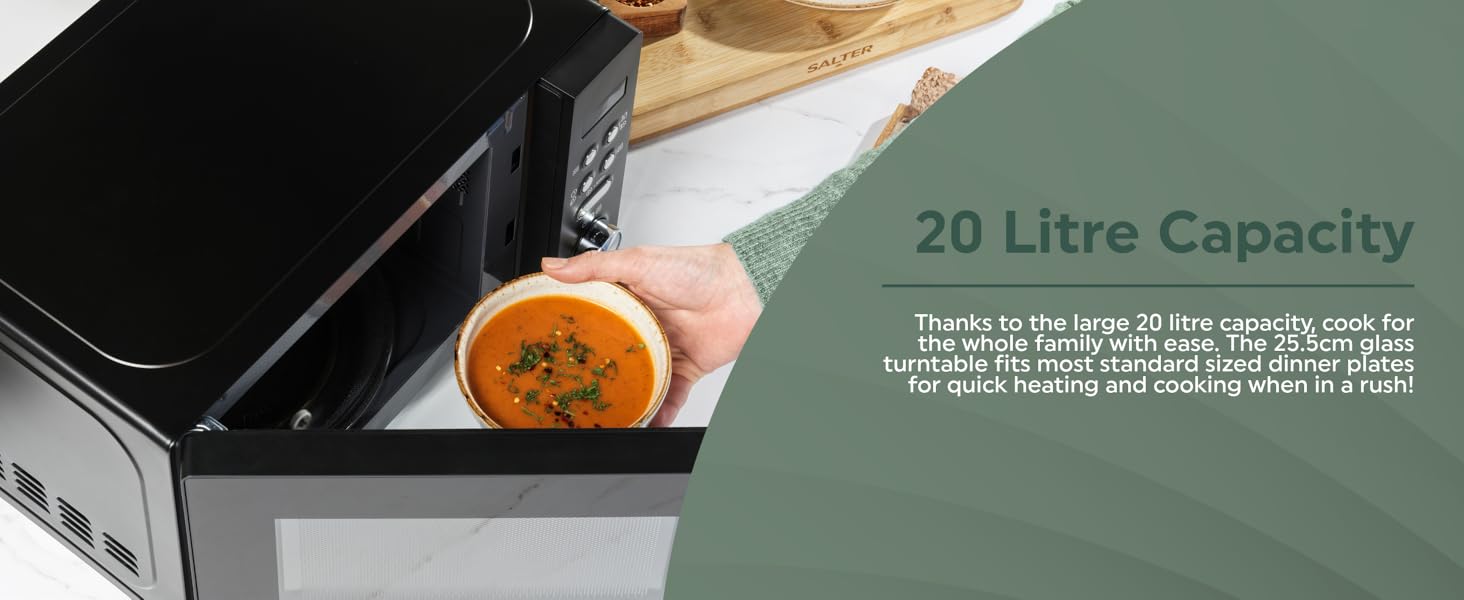 Person opening microwave with bowl of soup inside.