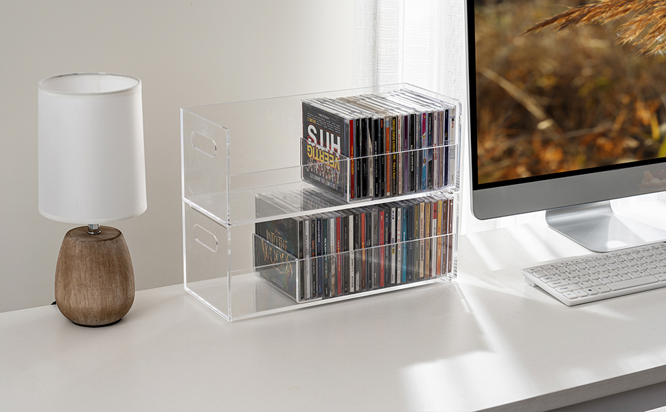clear acrylic CD compact disc holder rack bins with dividers on a desktop
