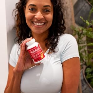 Woman with Turmeric Curcumin bottle