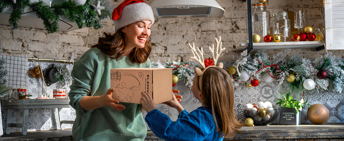 a mother and daughter opening a christmas gift box