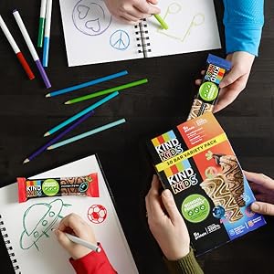 Teacher passing out portable KIND Kids bars as a snack during class activity