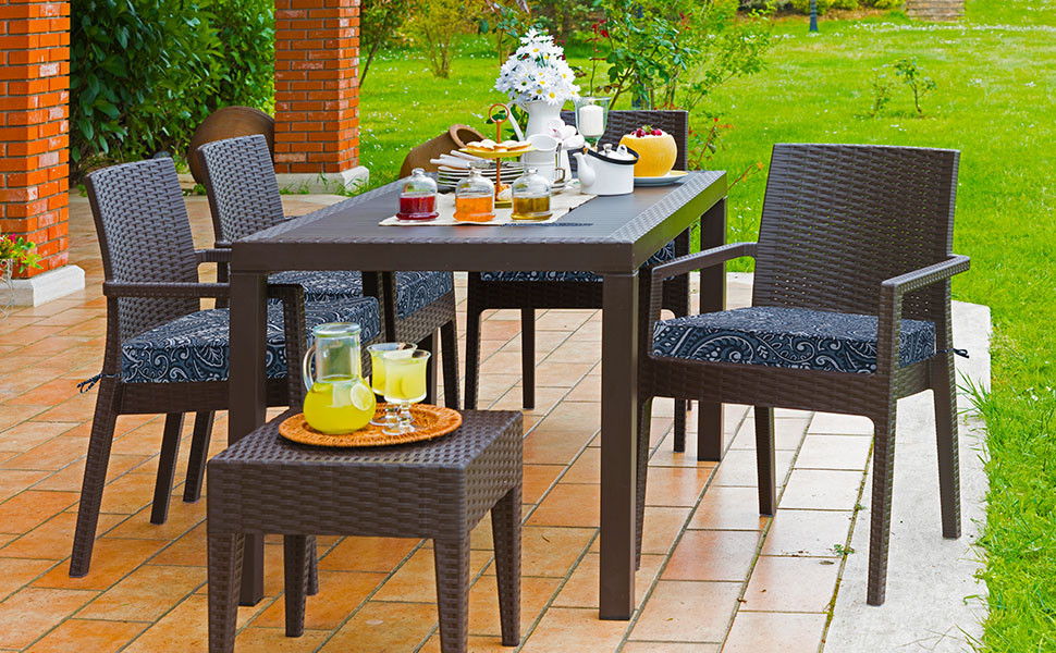 All - weather wicker outdoor dining set with damask blue flower cushions