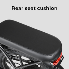 Black padded rear seat cushion for a bicycle or motorcycle. Rectangular shape with visible mounting hardware underneath.