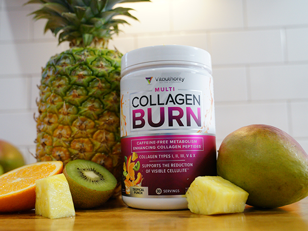 Single bottle of Multi Collagen Burn Tropical Punch surrounded by several pieces of fruit