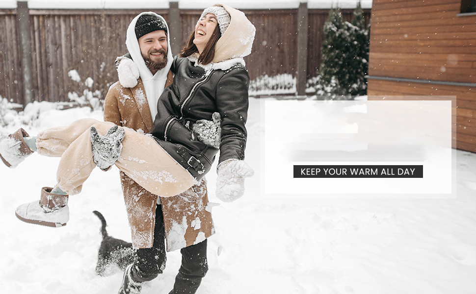 a couple in the snow with a dog