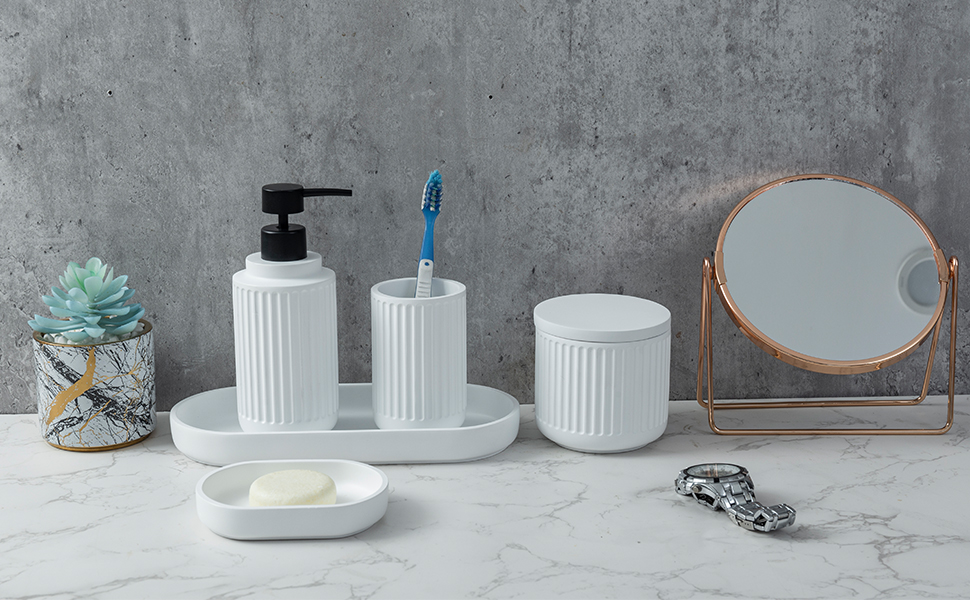 5 piece bathroom accessory set with white ceramic ribbed design on a countertop with small mirror