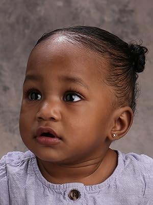 Gold ball earing on little girl