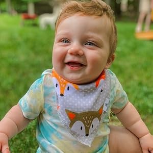 baby boy smiling outside in his fox bib