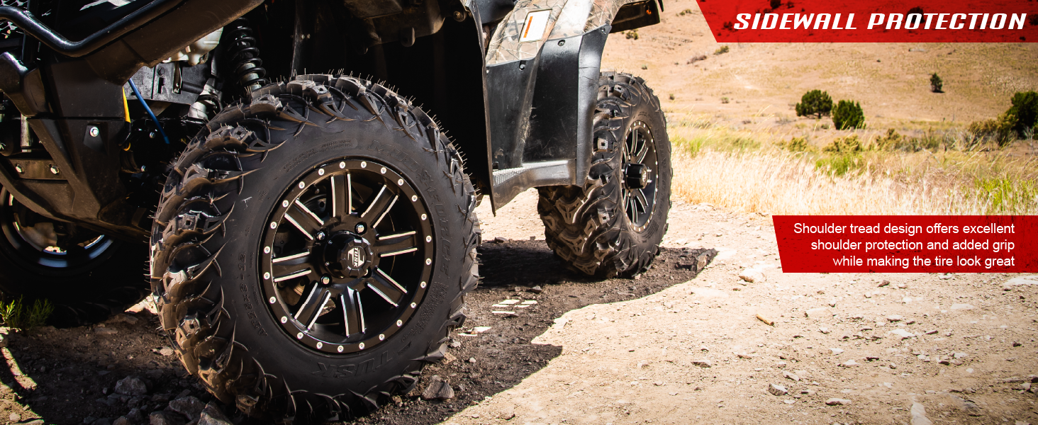 Close up of ATV equipped with Tusk Mud Force tires on a dirt road