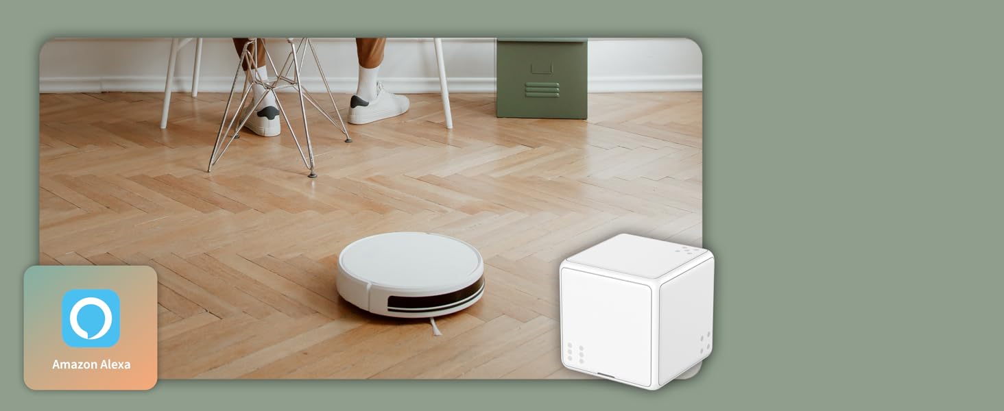a robot that is sitting on a floor next to a white box.