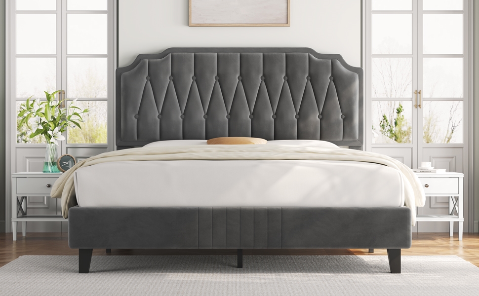 Modern upholstered bed frame with a tall, diamond-tufted gray headboard, shown in a bright bedroom setting with white nightstands.