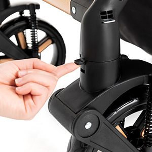 Close-up of a black cylindrical mechanism, possibly part of a bicycle or stroller, being adjusted by a hand using an Allen wrench.