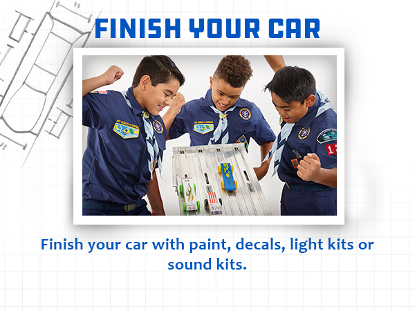 Three boyscout kids playing Pinewood Derby