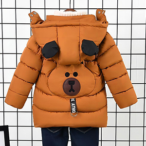 Children's puffer jacket in orange with bear-like design. Features ears on hood, black paw prints on chest, and a zipper with bear face. Hanging on wire grid.