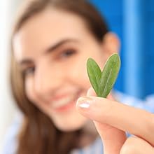 girl holding leaf up close