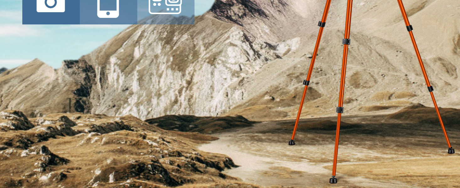 Orange tripod legs set up on rocky, mountainous terrain. Background shows rugged peaks and a barren landscape.