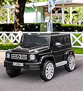 Black Mercedes-Benz G-Class ride-on toy car for children, parked on outdoor patio with white fence and greenery in background.