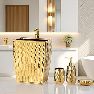 gold bathroom accessories and trash can