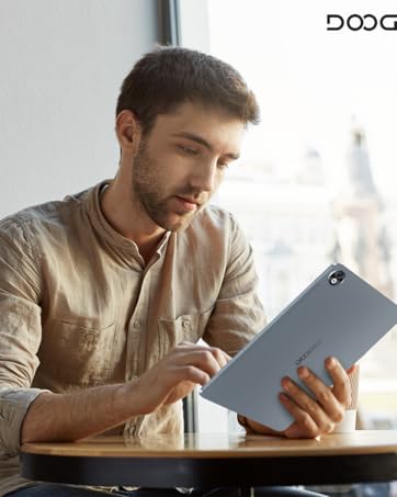 Gray tablet device being used in a casual setting, with Doogee branding visible. Shown in landscape orientation during typical use.