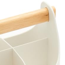 Close-up of a white plastic organizer with compartments and a wooden handle, showing partial view of the storage solution.