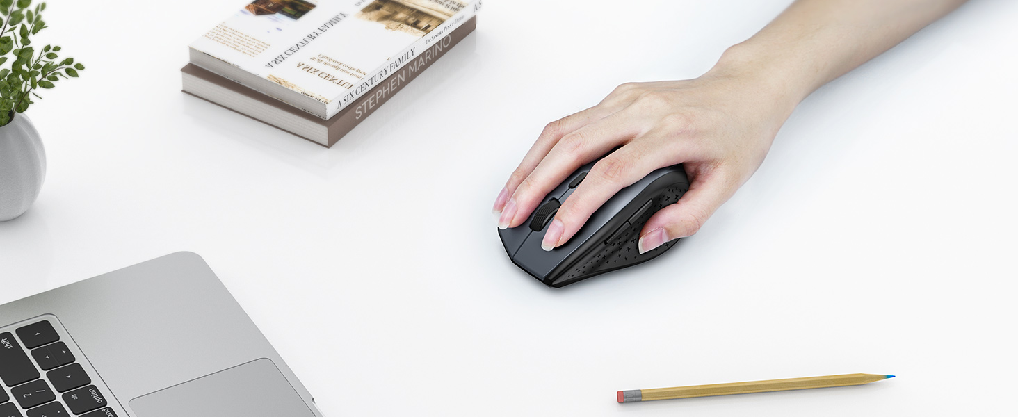 a hand is holding a mouse on a desk.
