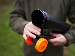 Sequence showing hands working with bright orange decorative elements against a dark background.