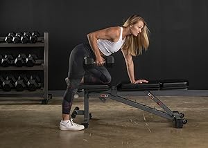 Female lifting dumbbell bench
