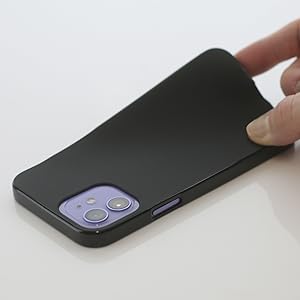 Black smartphone case being handled, showing dual camera cutouts with purple accents on what appears to be an iPhone.