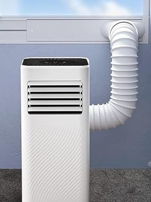 White portable air conditioning unit with retractable hose placed on gray floor against light blue walls.