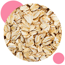 Gros plan de flocons d'avoine dans un cadre circulaire, entouré de cercles roses sur fond blanc