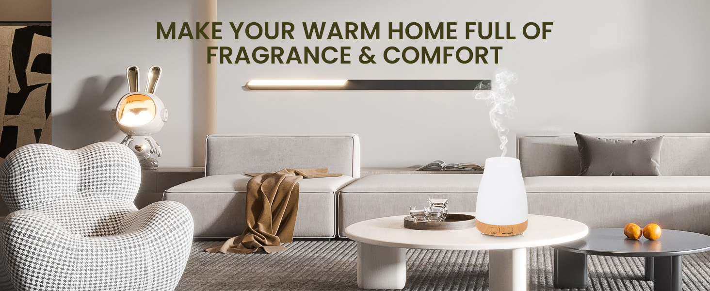 Text reads 'MAKE YOUR WARM HOME FULL OF FRAGRANCE & COMFORT'. Modern living room interior with gray couch, throw blanket, and decorative items on coffee table.
