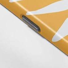 Close-up of a yellow and white patterned surface with a metal clip or fastener visible along the edge, suggesting a binder or folder.