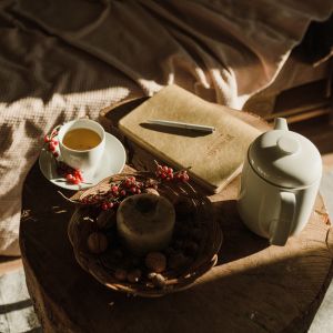 Close-up sequence showing hands pouring and preparing a hot beverage, likely coffee or tea, in warm lighting conditions.