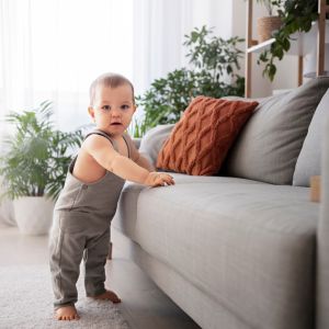 Baby lying on milestone photo mat with numbers and time markers (Days, Weeks, Months, Years)