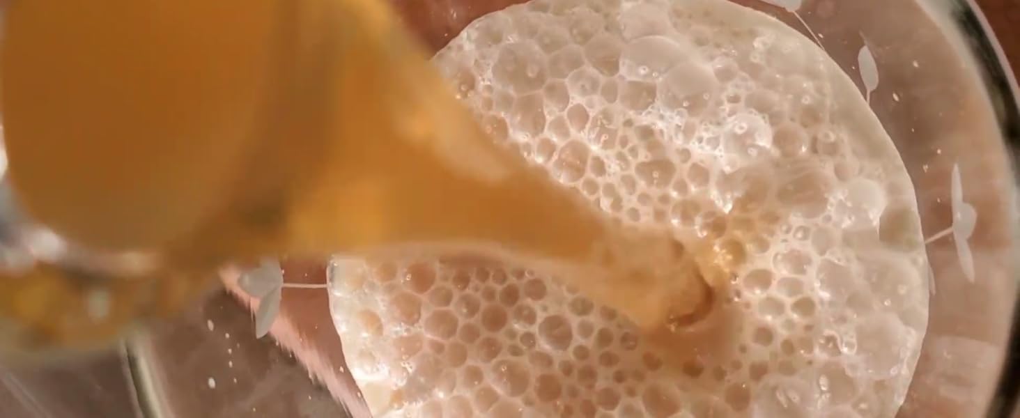 pouring double-fermented kefir concoction into glass with cream; water kefir starter grains; 