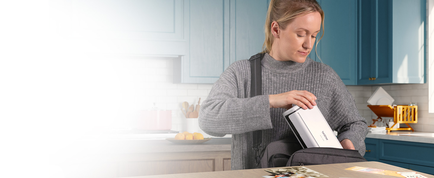 Woman placing ADS-1300 compact scanner into messenger bag, to carry between home and the office