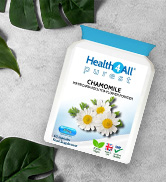 White bottle of chamomile supplement capsules. Label shows 'HealthPay' brand, mentions 'clinically proven', and displays chamomile flower imagery. Green leaves frame the product.
