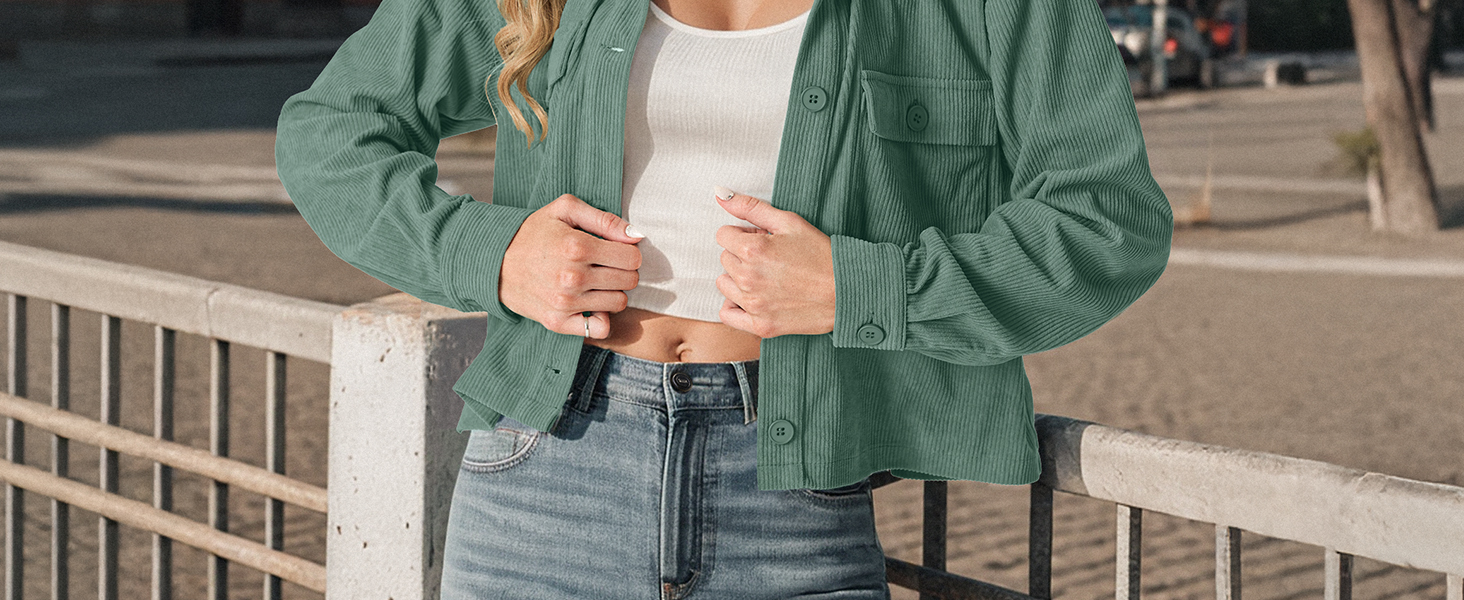 Green corduroy jacket with puffy sleeves and zipper closure, shown worn with light jeans against outdoor setting.
